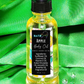 Bottle of Apple Body Oil with dropper on a green fabric background
